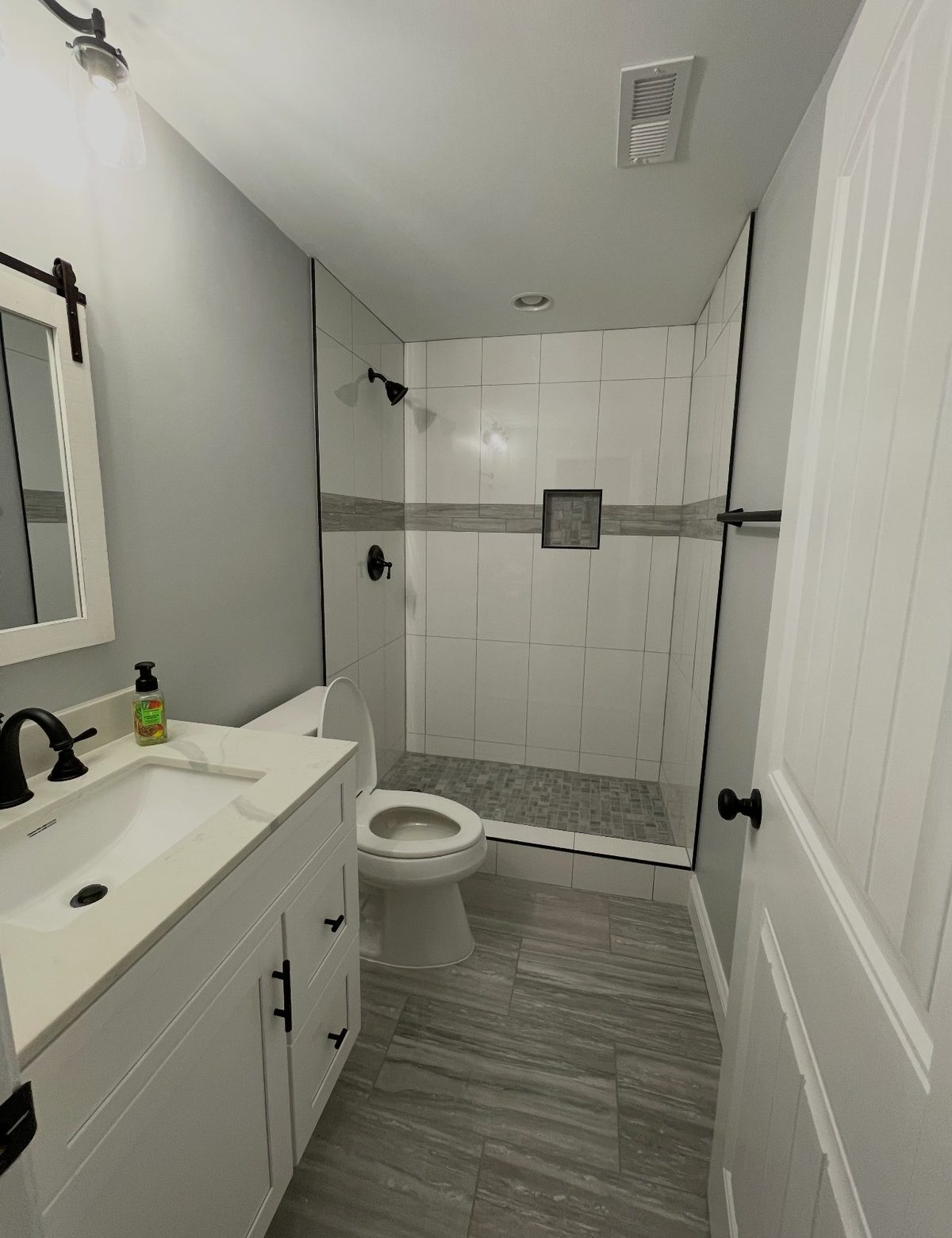 Bathroom remodel with white vanity and walk in shower by Home Fix Pro in Purcellville VA