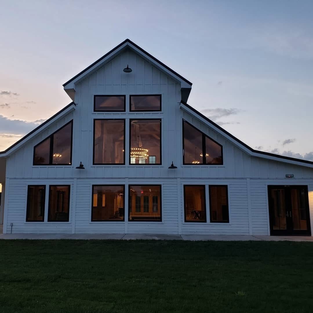 Metal roof, board and batten siding and new windows on a custom home exterior by Home Fix Pro in Purcellville VA