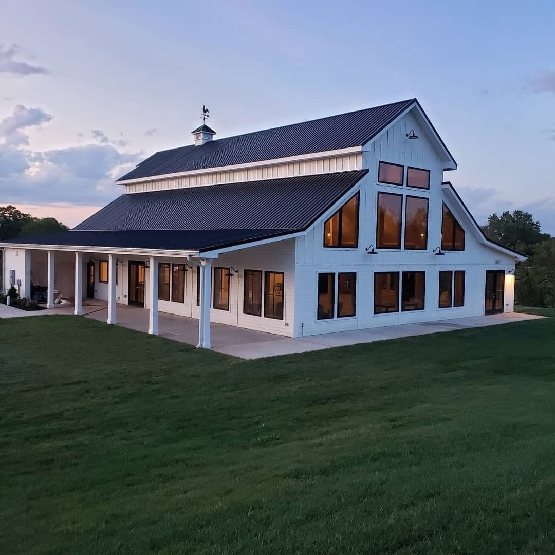 Custom home with a standing seam metal roof and covered porch by Home Fix Pro in Purcellville VA