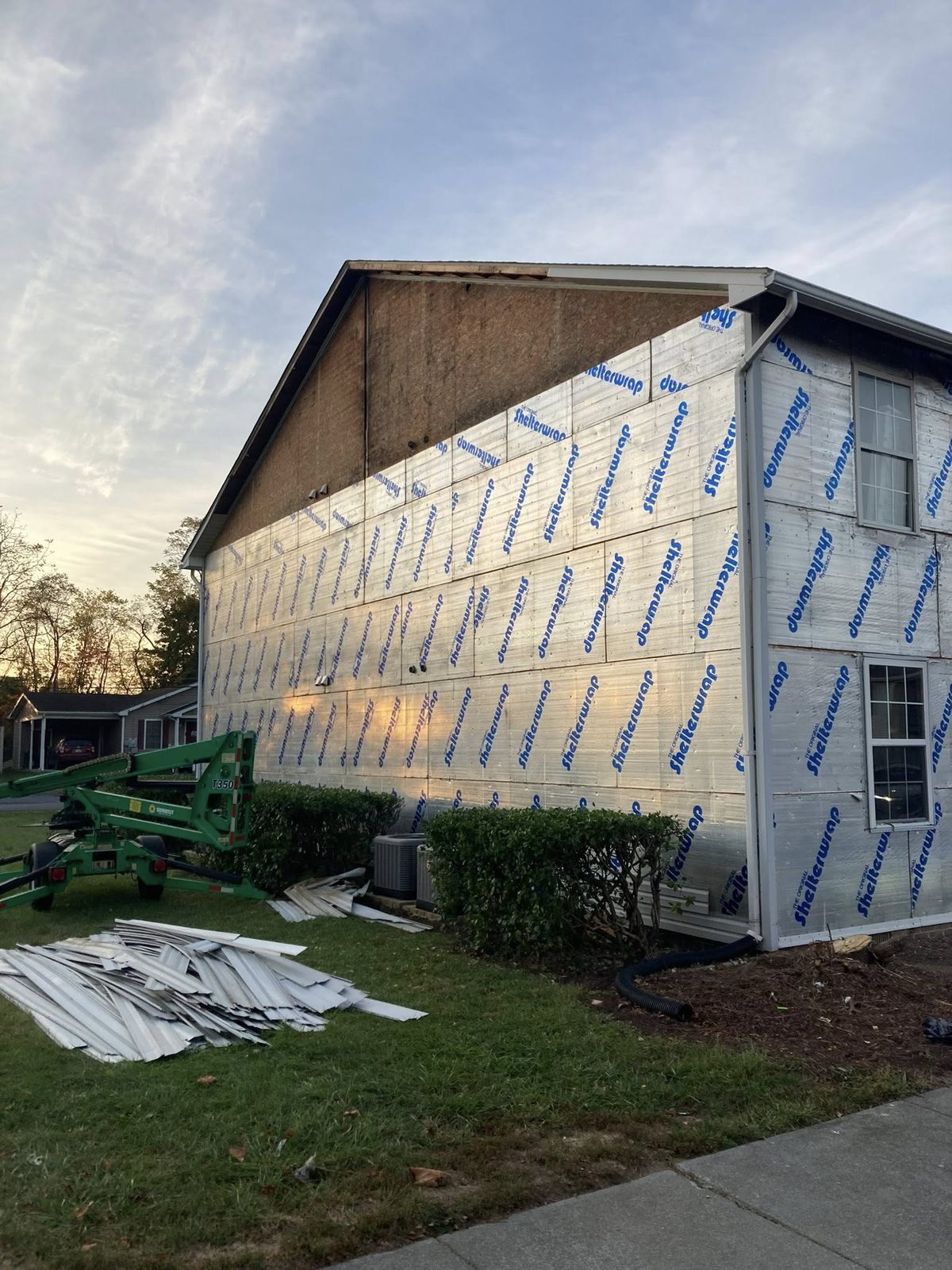 Siding removal in progress with boom lift by Home Fix Pro in Purcellville VA